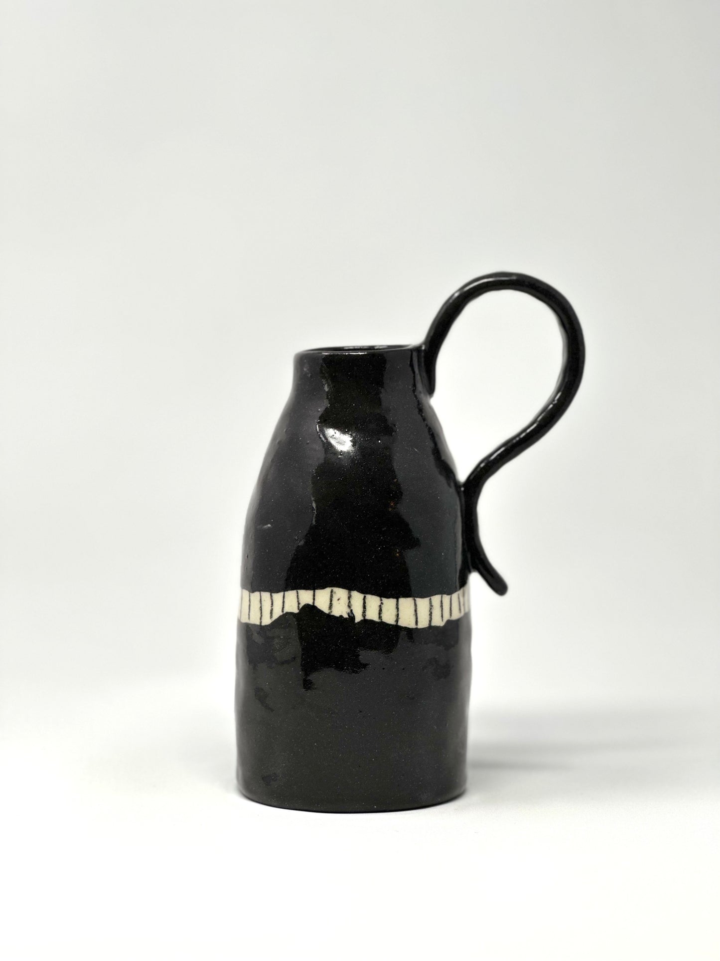 black clay jug with BIG handle