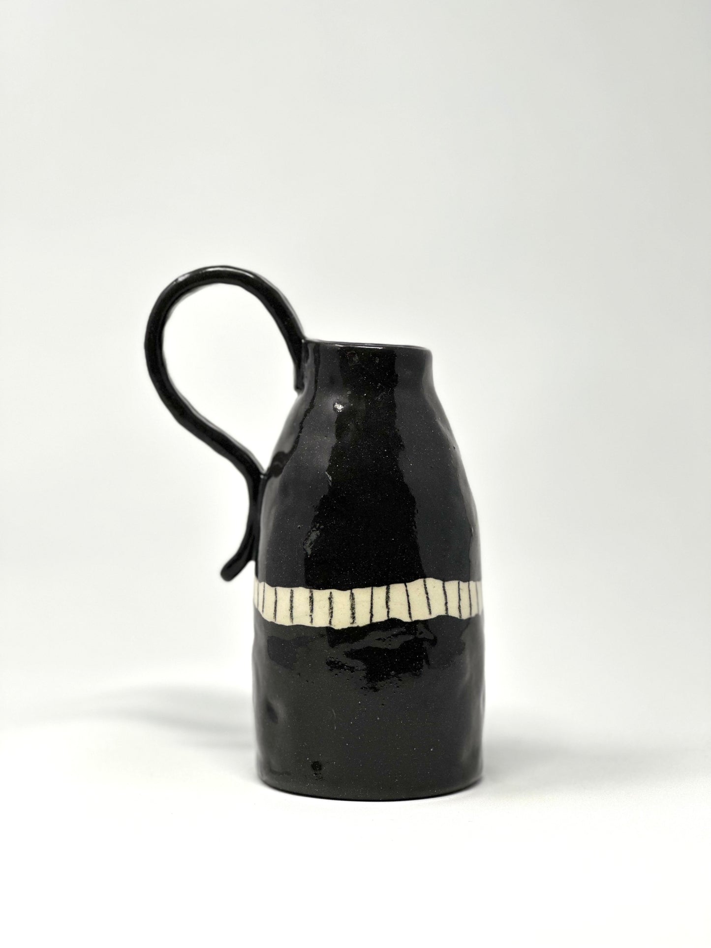 black clay jug with BIG handle