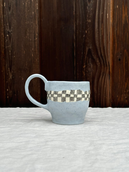 blue clay mug with pencil check