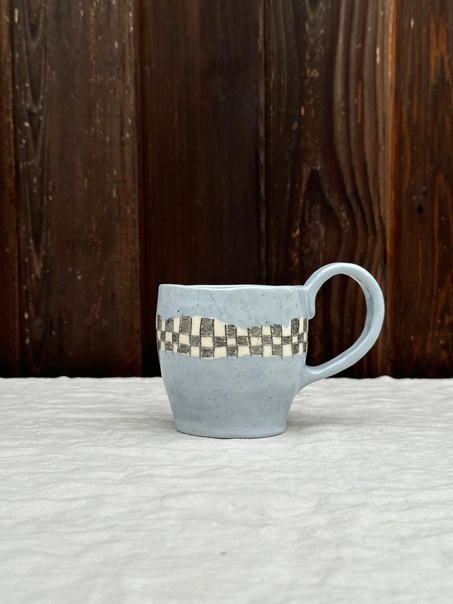 blue clay mug with pencil check