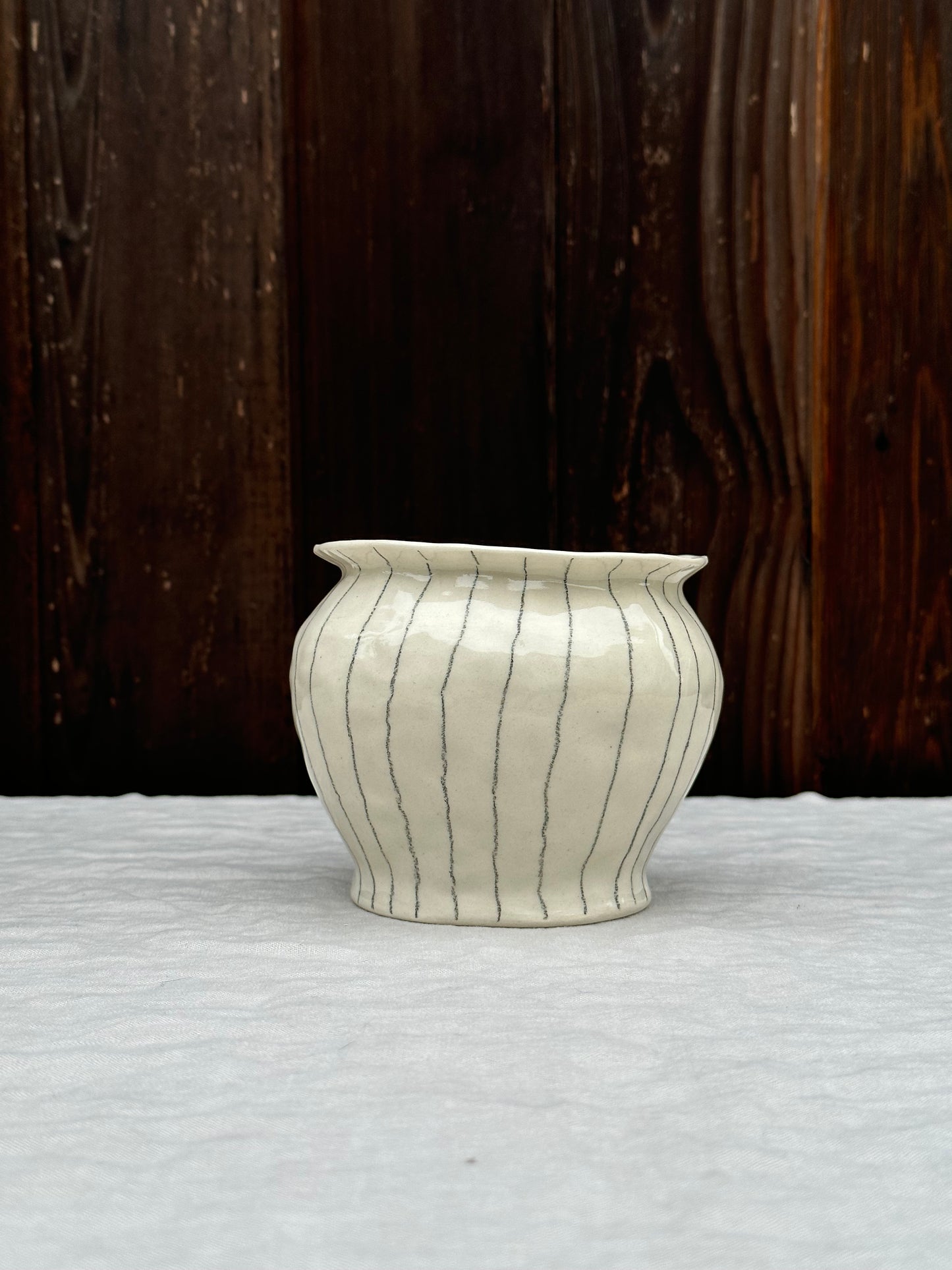 white low vase with rim and pencil stripe