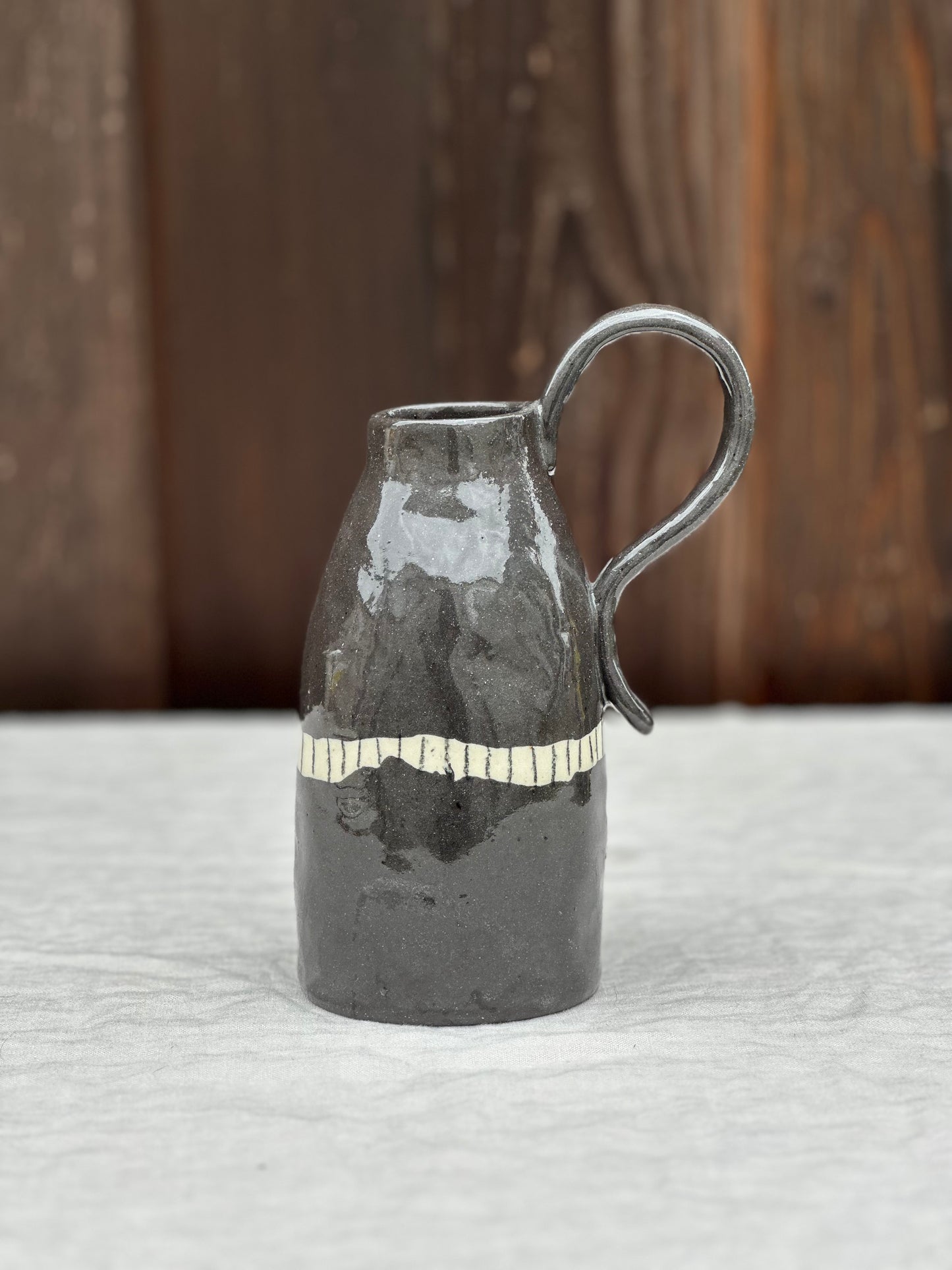 black clay jug with BIG handle