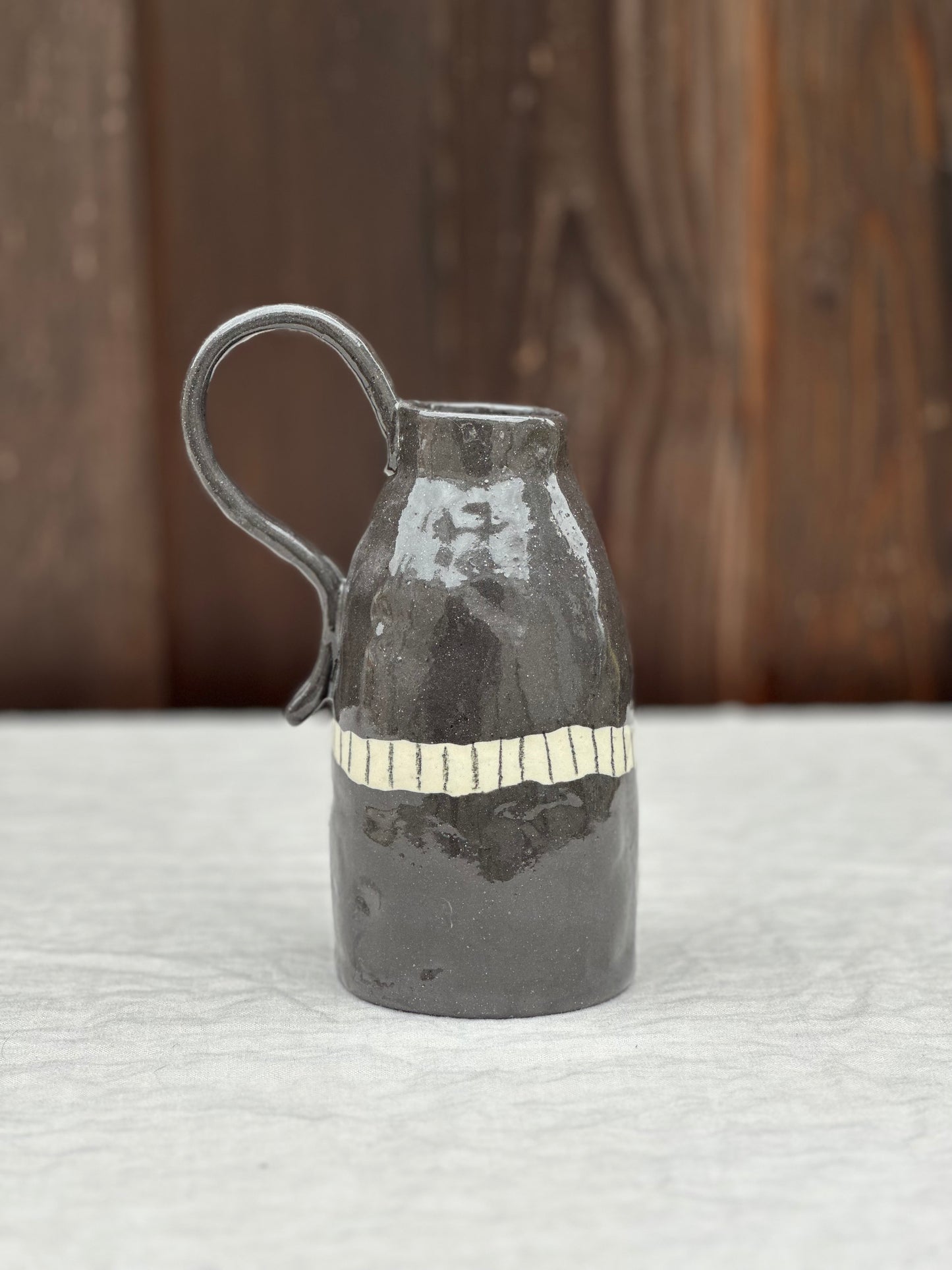 black clay jug with BIG handle